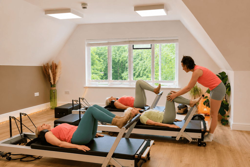group of people taking part in a Reformer Pilates Class at Shine at The Hollies