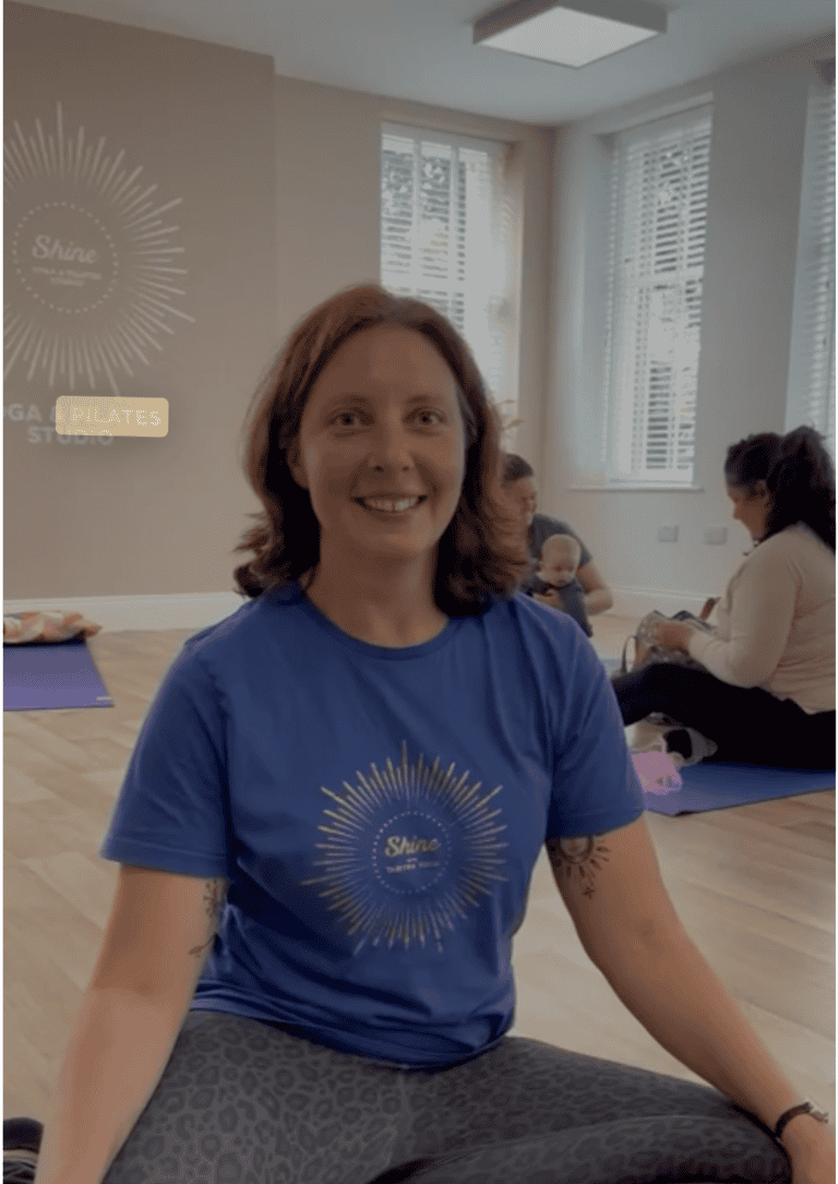 young smiling woman with auburn hair, called Emily, yoga teacher at Shine at The Hollies