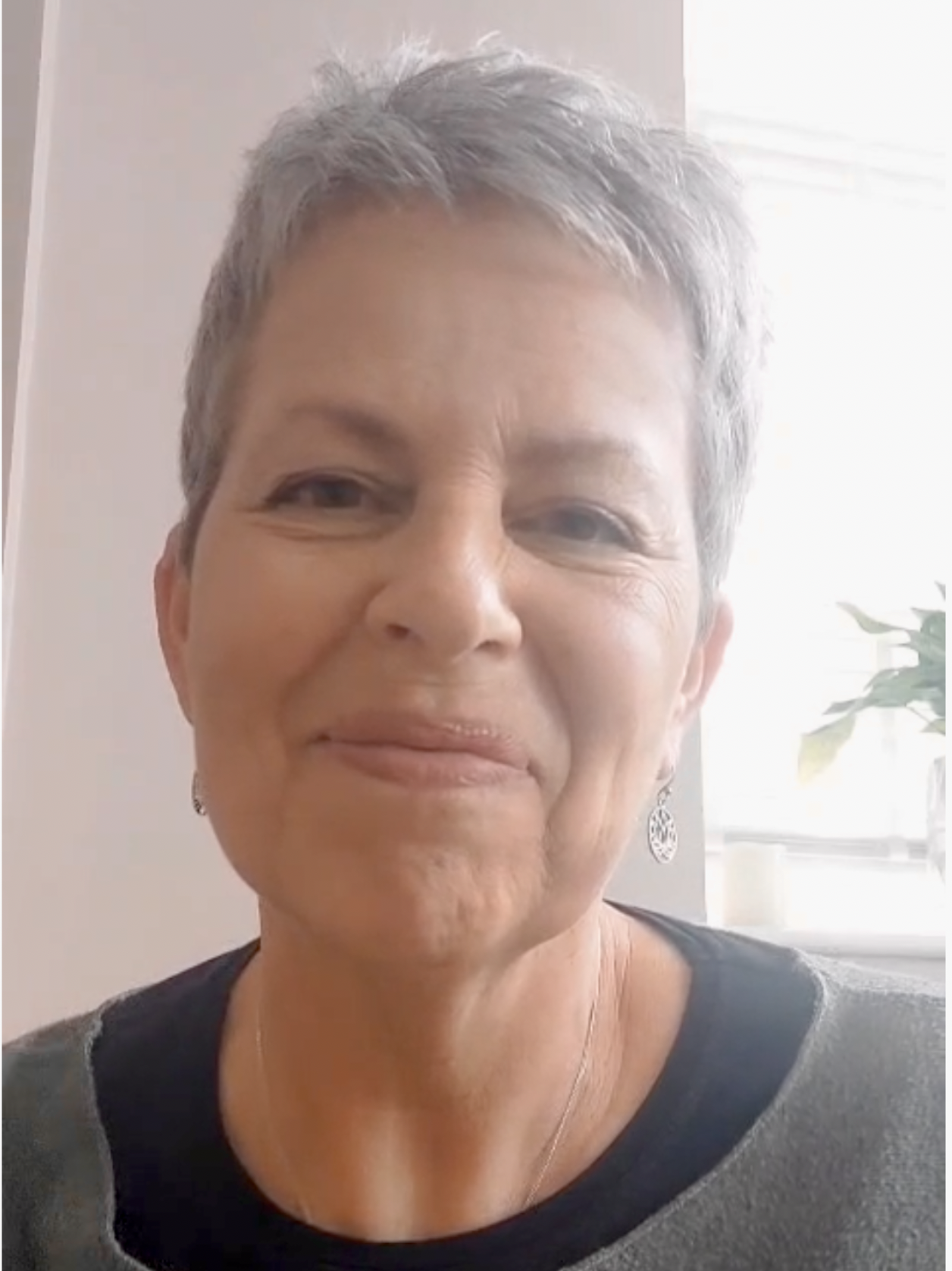 Image of Sue, a middle age woman, smiling, who runs Yoga for Cancer Care at Shine at the Hollies