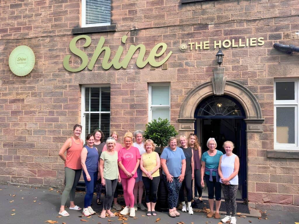 Group of women standing outside Shine at the Hollies after having done a Pilates class