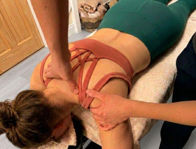 woman lying on a treatment bed face down at Shine wellbeing receiving a Sports Therapy massage with Lauren