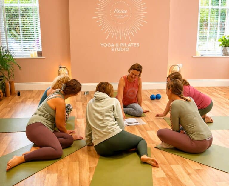 group of students sitting with the teacher at Shine at the Hollies during the Mat Pilates Teacher Training course studying lesson plans