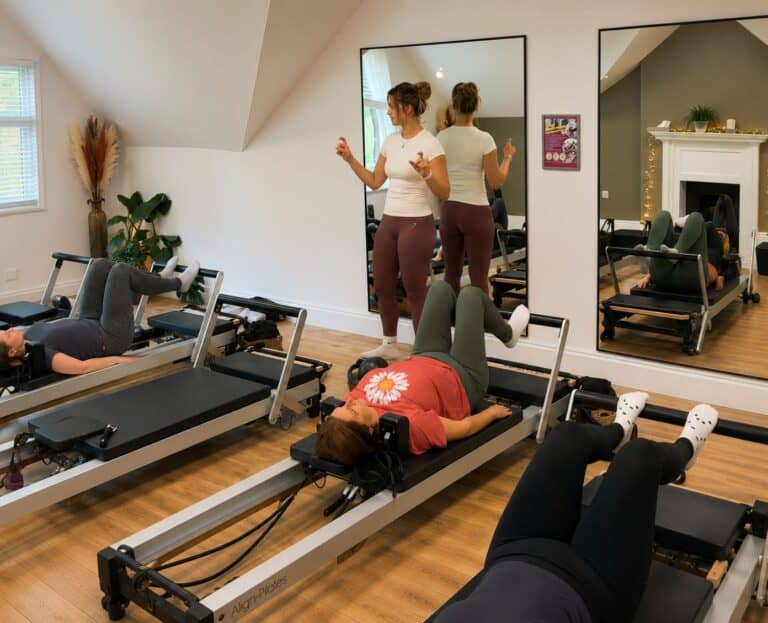 Teacher at Shine at The Hollies teaching a Reformer Pilates class as part of the Reformer Pilates Teacher Training course